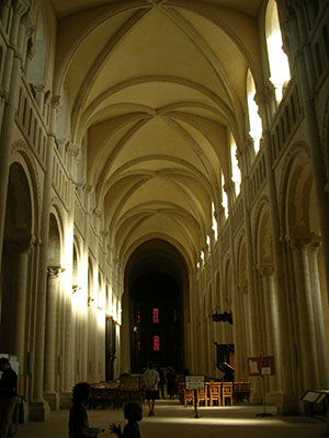 a stone room in a church with rounded arches