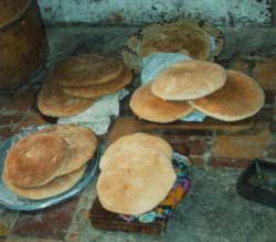 African Food - History - Cooking and eating in early Africa Flat round pita breads on plates - Early African food