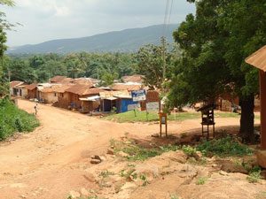 red dirt roads and a small group of thatched huts