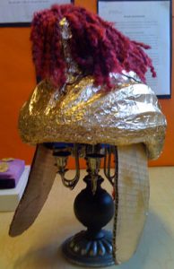A Roman helmet model made out of a bike helmet covered with tinfoil