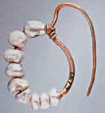 A Roman earring: about a dozen irregular pearls strung on gold wire