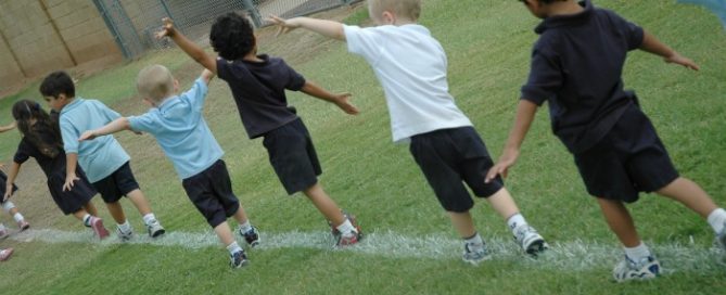 Kids walking along a chalk line.